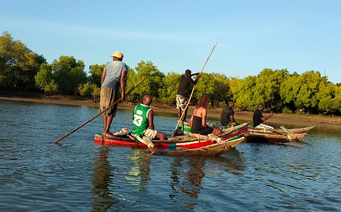 Visitors enjoying a traditional canoe ride on the Kongo River estuary in Diani, Kenya