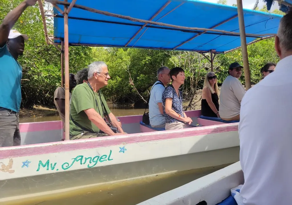 Visitors enjoying a peaceful boat ride through mangrove waterways in Gazi Bay Kenya