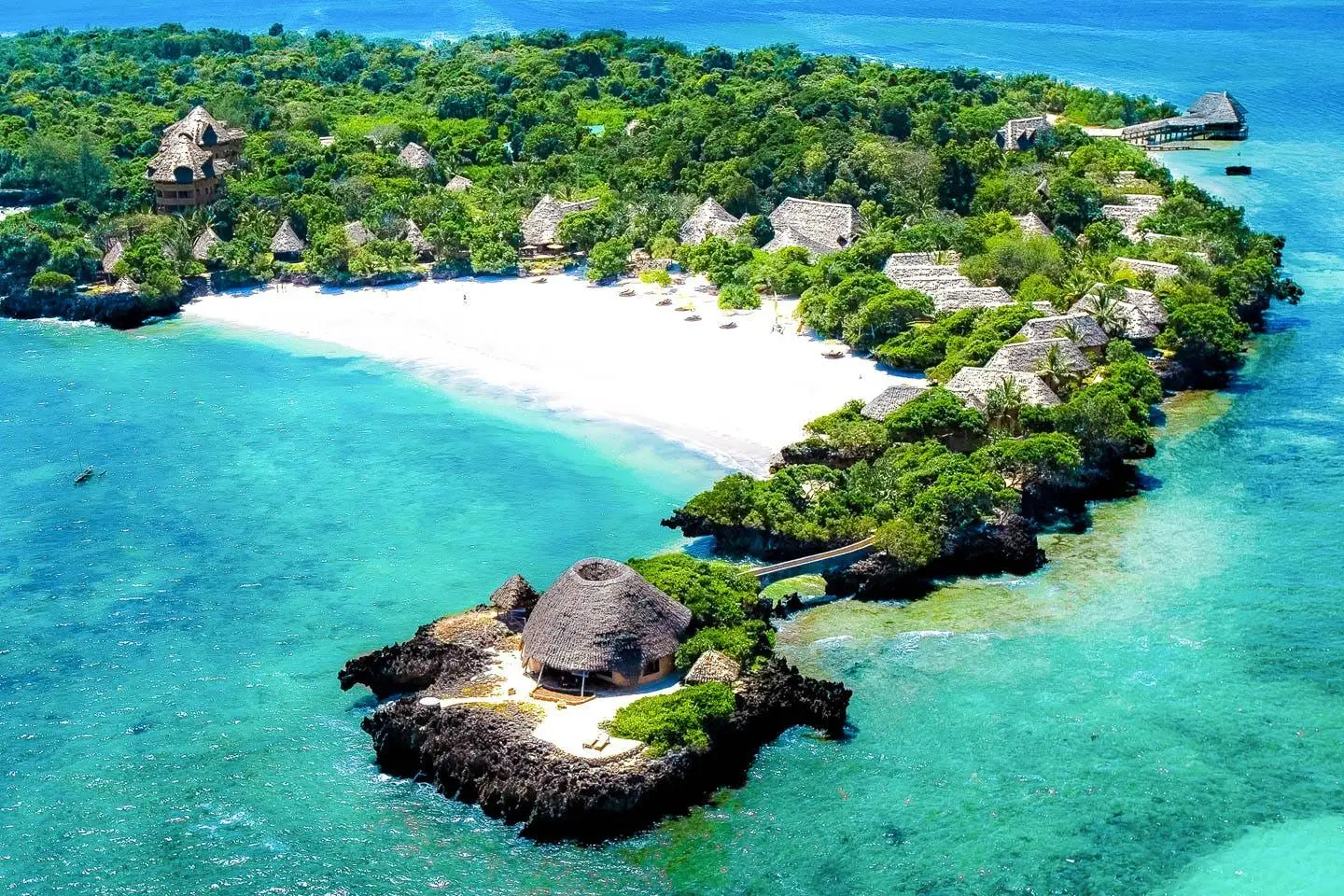 Quiet white sandy beach and tropical scenery on Chale Island near Diani