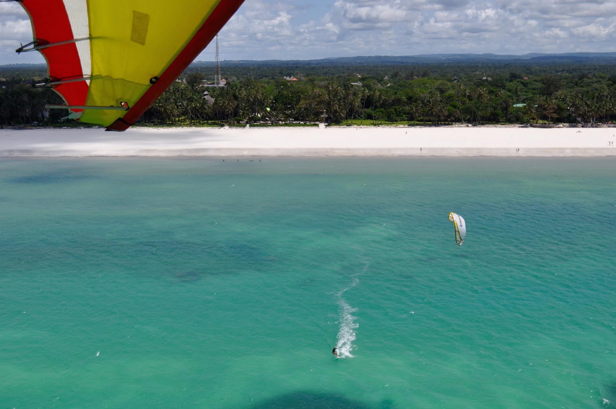 Kitesurfer riding across the turquoise lagoon at Galu Beach in Diani Kenya