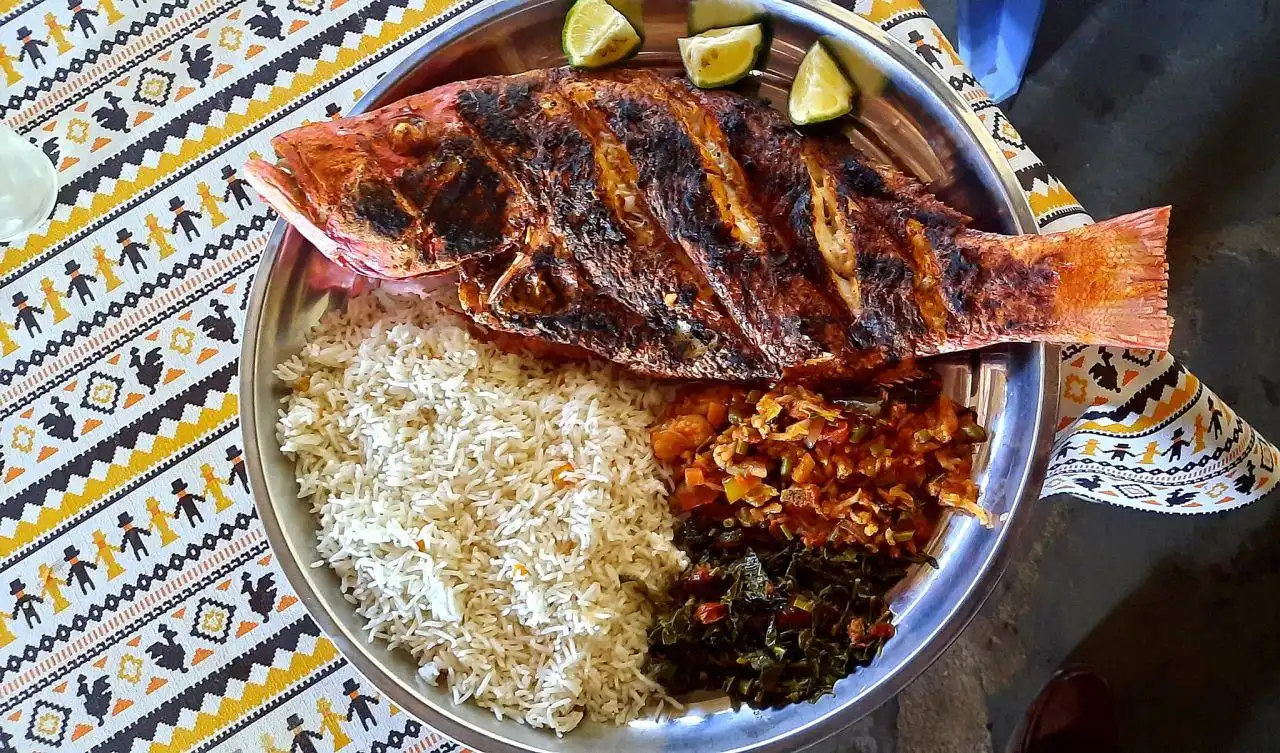 Swahili seafood lunch served with coconut rice and vegetables on the Kenyan coast.